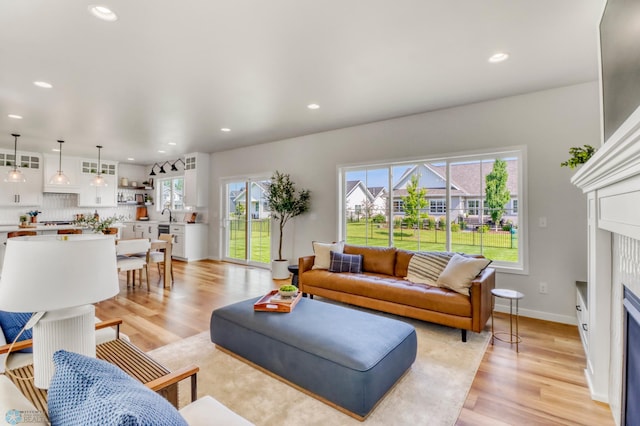 6176 Marigold Loop S, Fargo, ND 58104 - living area with light wood-style floors, recessed lighting, and a fireplace