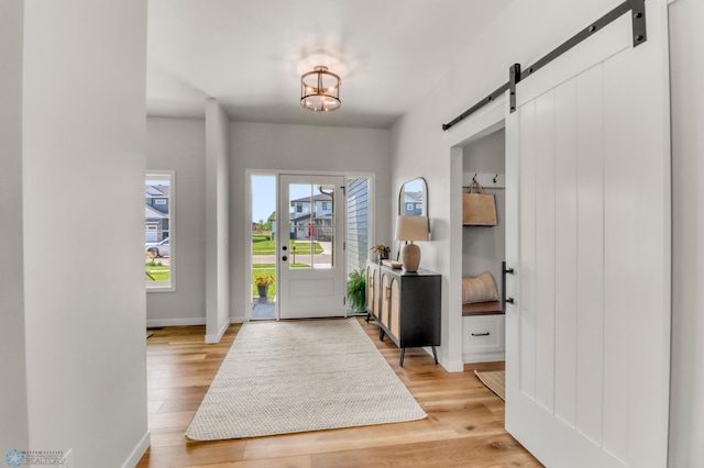 6176 Marigold Loop S, Fargo, ND 58104 - entryway featuring a barn door, light wood-style flooring, and a chandelier