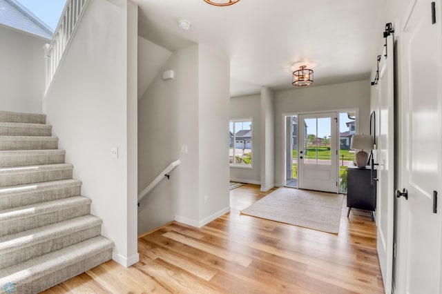 6176 Marigold Loop S, Fargo, ND 58104 - foyer entrance featuring a barn door, light wood-type flooring, and stairway