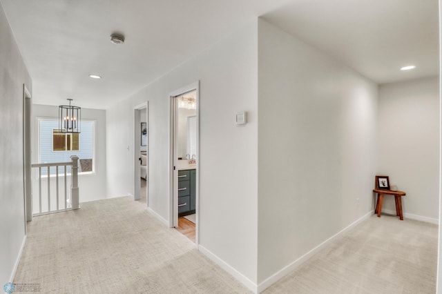 6176 Marigold Loop S, Fargo, ND 58104 - hall with light colored carpet, an upstairs landing, recessed lighting, and a chandelier