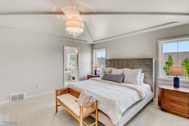 6176 Marigold Loop S, Fargo, ND 58104 - bedroom with light carpet, multiple windows, lofted ceiling, and connected bathroom