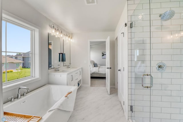 6176 Marigold Loop S, Fargo, ND 58104 - full bath featuring ensuite bathroom, a shower stall, a freestanding tub, vanity, and marble look tiles