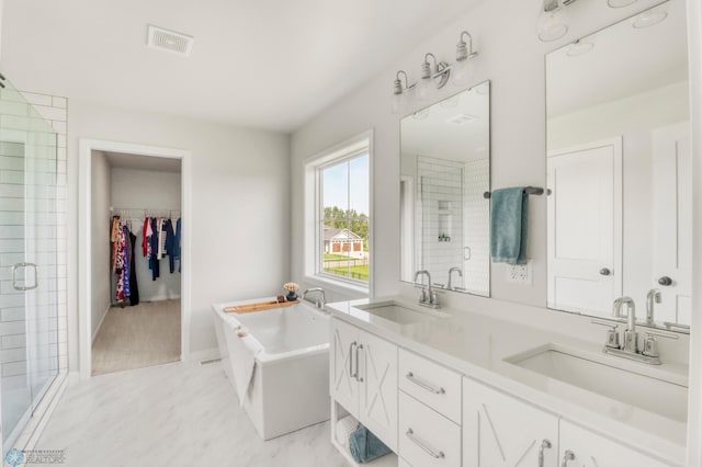 6176 Marigold Loop S, Fargo, ND 58104 - bathroom featuring a stall shower, a freestanding tub, double vanity, and a spacious closet