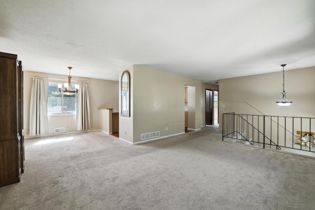 1958 6th St N, North Saint Paul, MN 55109 - spare room featuring a chandelier and carpet floors