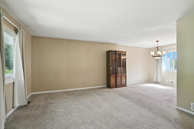 1958 6th St N, North Saint Paul, MN 55109 - carpeted empty room featuring a chandelier and baseboards