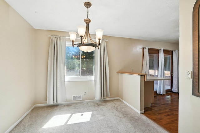 1958 6th St N, North Saint Paul, MN 55109 - unfurnished dining area with a chandelier and carpet flooring