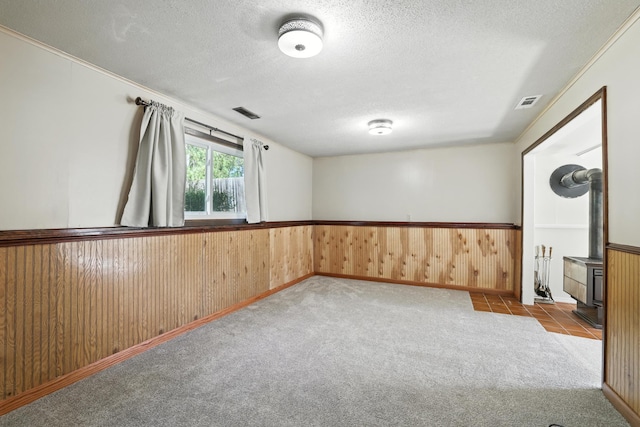 1958 6th St N, North Saint Paul, MN 55109 - spare room with a wainscoted wall, a textured ceiling, carpet flooring, and wood walls