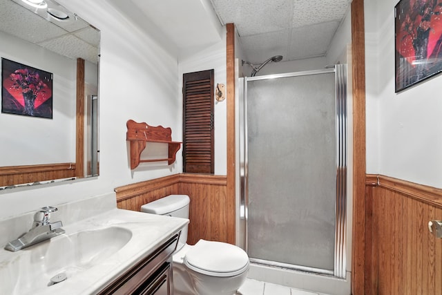 1958 6th St N, North Saint Paul, MN 55109 - bathroom featuring a drop ceiling, wainscoting, a shower stall, vanity, and wood walls