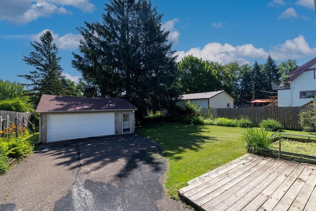 1958 6th St N, North Saint Paul, MN 55109 - view of yard featuring an outdoor structure, a detached garage, and a deck
