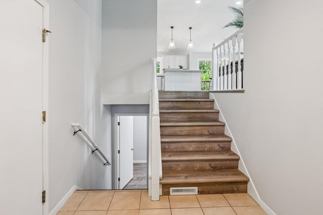 1318 Windcrest Ave, Eagan, MN 55123 - stairs featuring tile patterned flooring and baseboards