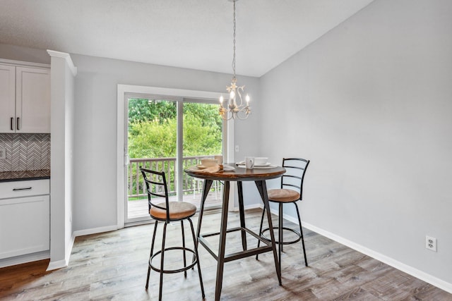 1318 Windcrest Ave, Eagan, MN 55123 - dining space featuring light wood-type flooring, a chandelier, and lofted ceiling