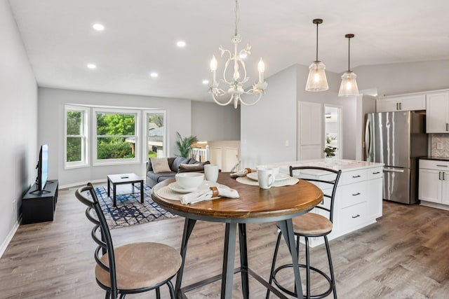 1318 Windcrest Ave, Eagan, MN 55123 - dining area with a chandelier, lofted ceiling, wood finished floors, and recessed lighting