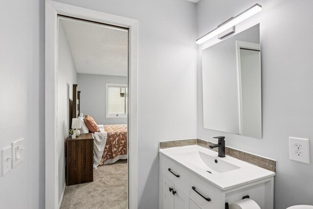 1318 Windcrest Ave, Eagan, MN 55123 - ensuite bathroom featuring vanity and a textured ceiling