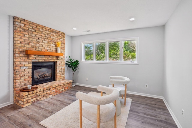 1318 Windcrest Ave, Eagan, MN 55123 - sitting room with a brick fireplace, wood finished floors, and recessed lighting
