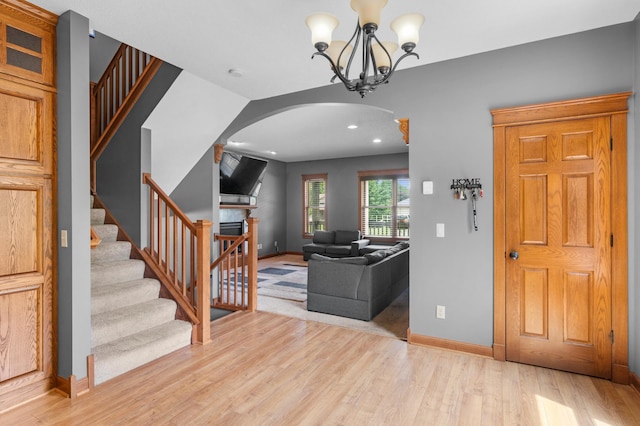 1222 81st Ct N, Brooklyn Park, MN 55444 - entrance foyer featuring arched walkways, light wood-style floors, stairs, recessed lighting, and a chandelier