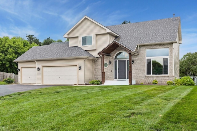 17964 Fresno St NW, Elk River, MN 55330 - view of front of home with asphalt driveway, roof with shingles, a garage, and brick siding
