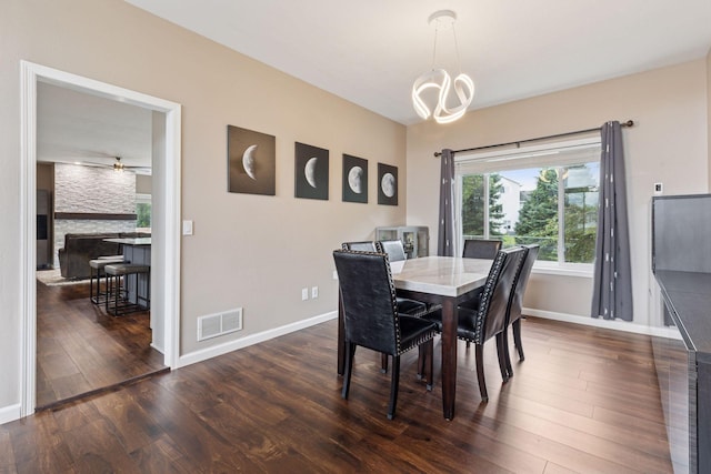 17964 Fresno St NW, Elk River, MN 55330 - dining space featuring dark wood finished floors, a chandelier, and a ceiling fan