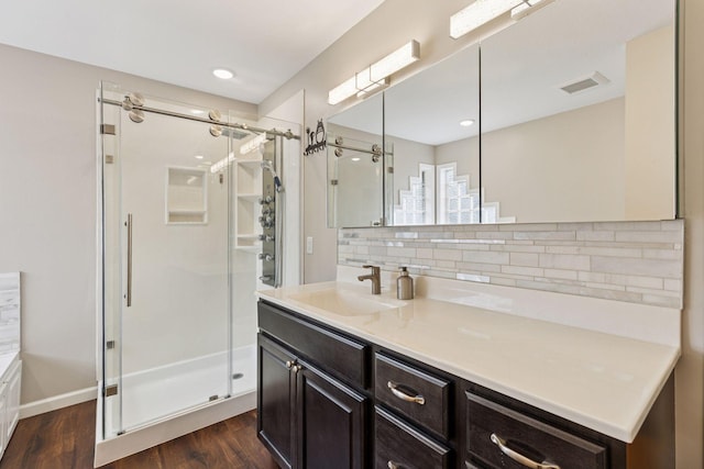 17964 Fresno St NW, Elk River, MN 55330 - full bath with a shower stall, wood finished floors, tasteful backsplash, vanity, and recessed lighting