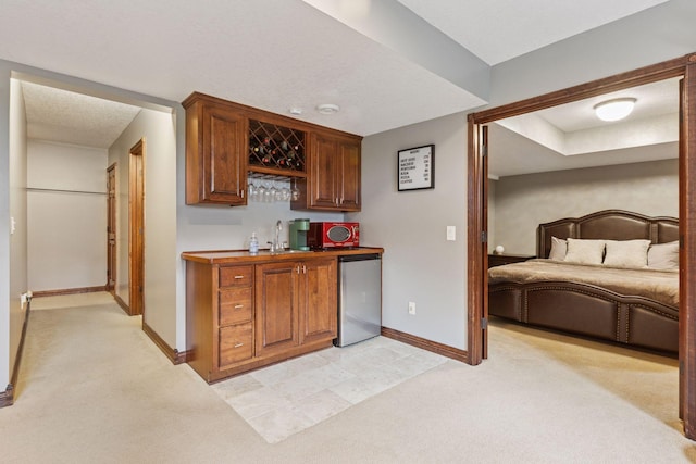 17964 Fresno St NW, Elk River, MN 55330 - indoor bar with light carpet and stainless steel refrigerator