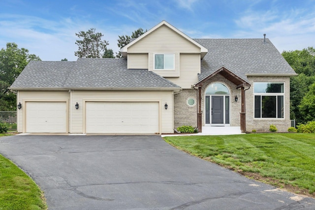 17964 Fresno St NW, Elk River, MN 55330 - traditional-style house with driveway, a garage, a front yard, a shingled roof, and brick siding