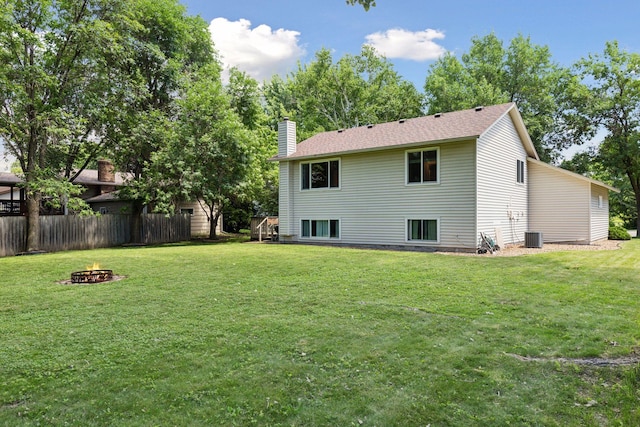 9743 Hemlock Ln N, Maple Grove, MN 55369 - rear view of property with an outdoor fire pit and a chimney