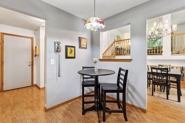 9743 Hemlock Ln N, Maple Grove, MN 55369 - dining room with a chandelier, wood finished floors, and stairs