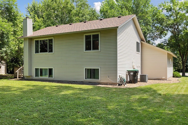 9743 Hemlock Ln N, Maple Grove, MN 55369 - back of property with a chimney, a lawn, and a shingled roof