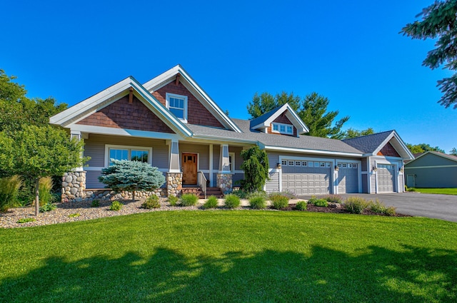 442 Wren Ln, Hudson, WI 54016 - craftsman-style house with a front yard, driveway, a garage, a porch, and stone siding