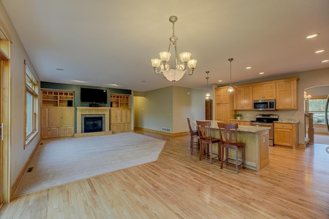 442 Wren Ln, Hudson, WI 54016 - kitchen with stainless steel appliances, a chandelier, recessed lighting, light wood finished floors, and a kitchen island