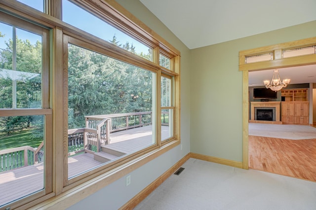 442 Wren Ln, Hudson, WI 54016 - spare room with a chandelier, a fireplace, and carpet flooring