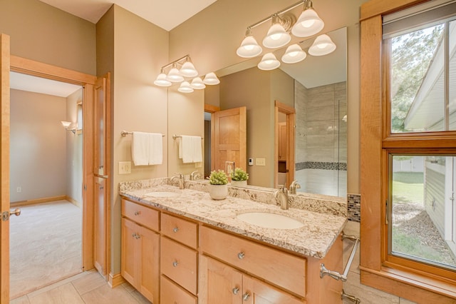 442 Wren Ln, Hudson, WI 54016 - bathroom with double vanity, a chandelier, tile patterned flooring, and tiled shower