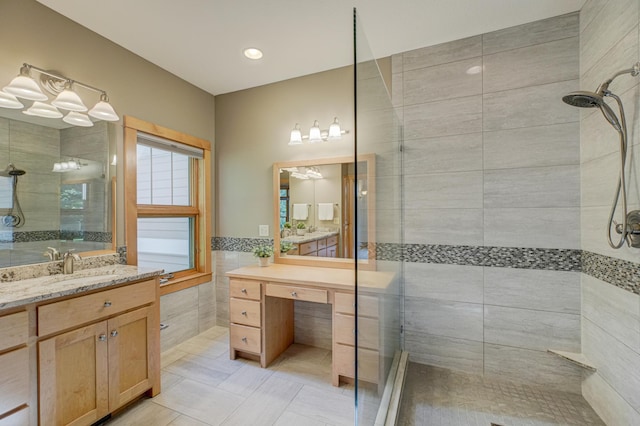 442 Wren Ln, Hudson, WI 54016 - full bath with a tile shower, tile walls, vanity, and tile patterned flooring