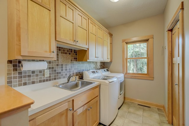 442 Wren Ln, Hudson, WI 54016 - washroom featuring independent washer and dryer, cabinet space, and light tile patterned floors