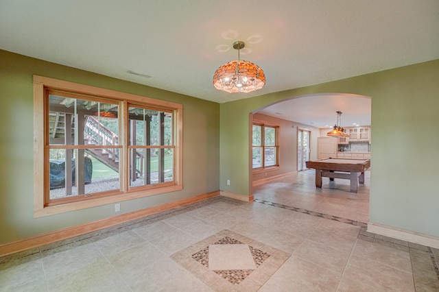 442 Wren Ln, Hudson, WI 54016 - spare room with arched walkways, billiards table, light tile patterned flooring, and inlaid floor details
