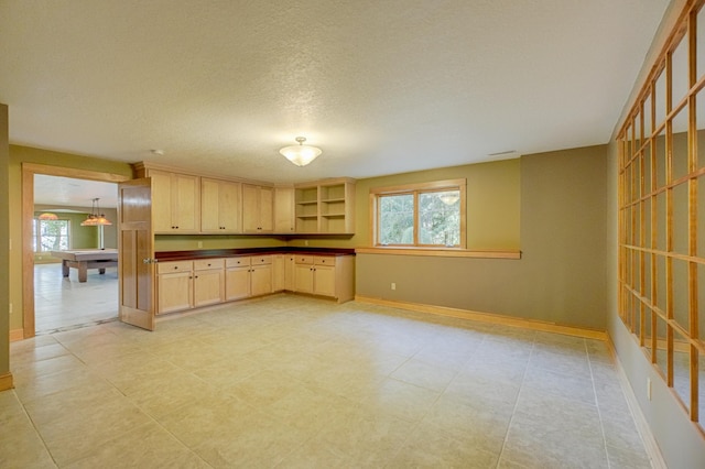 442 Wren Ln, Hudson, WI 54016 - kitchen with dark countertops, light brown cabinetry, open shelves, and a textured ceiling