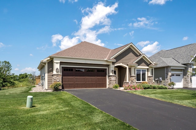 19400 75th Ave, Corcoran, MN 55340 - craftsman inspired home featuring stone siding, an attached garage, asphalt driveway, a front yard, and roof with shingles