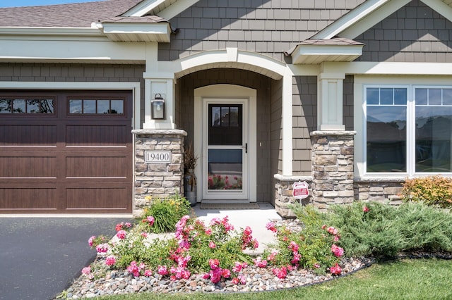 19400 75th Ave, Corcoran, MN 55340 - doorway to property with stone siding, a garage, and roof with shingles