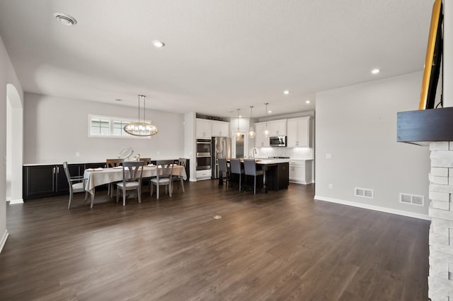 19400 75th Ave, Corcoran, MN 55340 - dining room featuring dark wood-style flooring, a chandelier, and recessed lighting