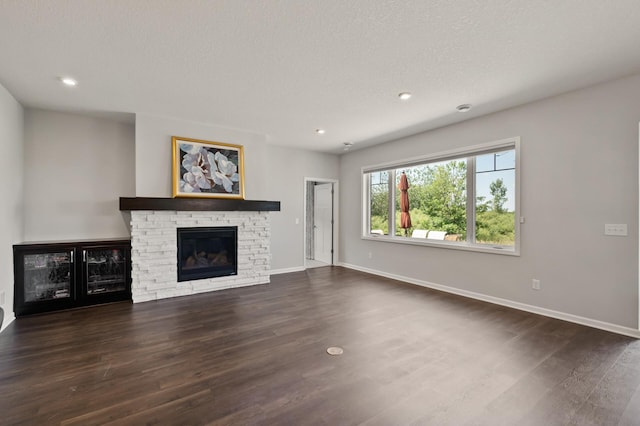 19400 75th Ave, Corcoran, MN 55340 - unfurnished living room with a stone fireplace, dark wood finished floors, and recessed lighting