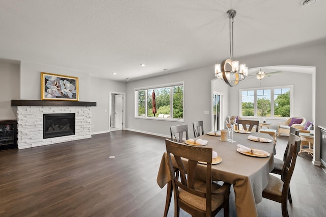 19400 75th Ave, Corcoran, MN 55340 - dining room featuring a stone fireplace, dark wood-type flooring, and a chandelier