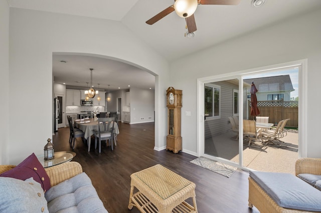 19400 75th Ave, Corcoran, MN 55340 - living room featuring arched walkways, a chandelier, ceiling fan, dark wood-style flooring, and vaulted ceiling