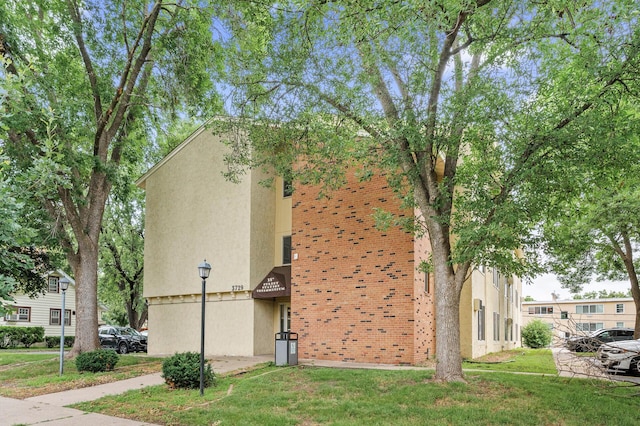 3729 Snelling Ave Unit 108, Minneapolis, MN 55406 - view of side of property featuring stucco siding and a yard