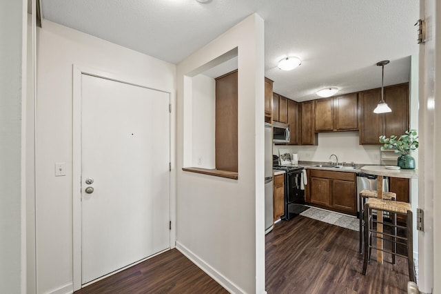 3729 Snelling Ave Unit 108, Minneapolis, MN 55406 - kitchen with black range oven, stainless steel microwave, dark wood-type flooring, light countertops, and a textured ceiling