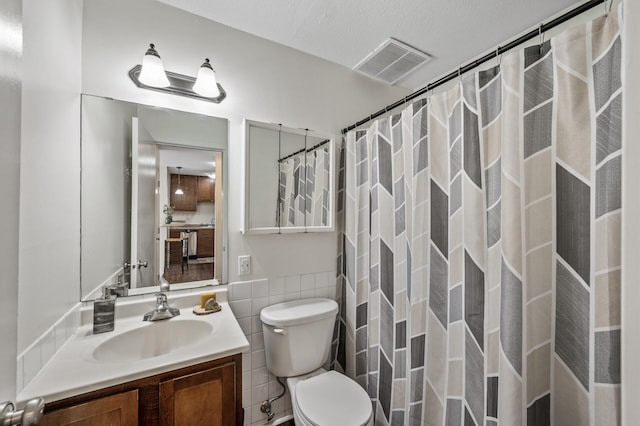 3729 Snelling Ave Unit 108, Minneapolis, MN 55406 - full bath with tile walls, vanity, a shower with shower curtain, and a wainscoted wall