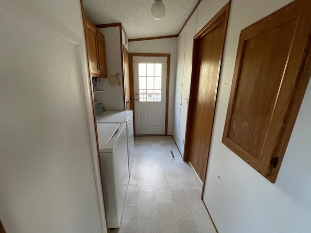 21344 County Road 11, Crosby, MN 56441 - laundry area featuring washing machine and clothes dryer, cabinet space, ornamental molding, and a textured ceiling