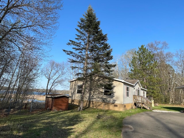 21344 County Road 11, Crosby, MN 56441 - view of property exterior featuring crawl space, a shed, and a yard