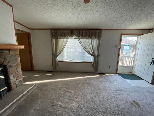 21344 County Road 11, Crosby, MN 56441 - unfurnished living room featuring a textured ceiling, healthy amount of natural light, carpet floors, ornamental molding, and a fireplace