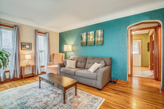 1821 Orange Ave E, Saint Paul, MN 55119 - living area with a textured wall, light wood-style floors, and arched walkways