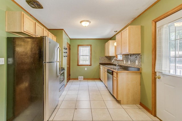 1821 Orange Ave E, Saint Paul, MN 55119 - kitchen featuring appliances with stainless steel finishes, light brown cabinets, dark countertops, backsplash, and crown molding