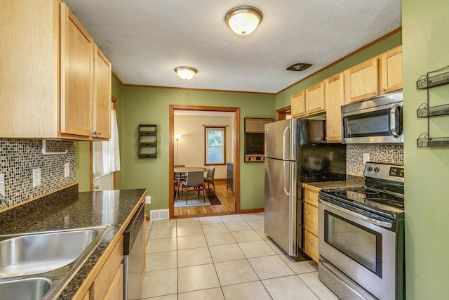 1821 Orange Ave E, Saint Paul, MN 55119 - kitchen with stainless steel appliances, light brown cabinets, decorative backsplash, light tile patterned flooring, and a textured ceiling